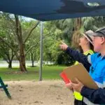 Playground Safety Auditors Identifying a Hazard Risk During Inspection Audit