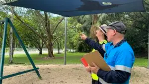 Playground Safety Auditors Identifying a Hazard Risk During Inspection Audit