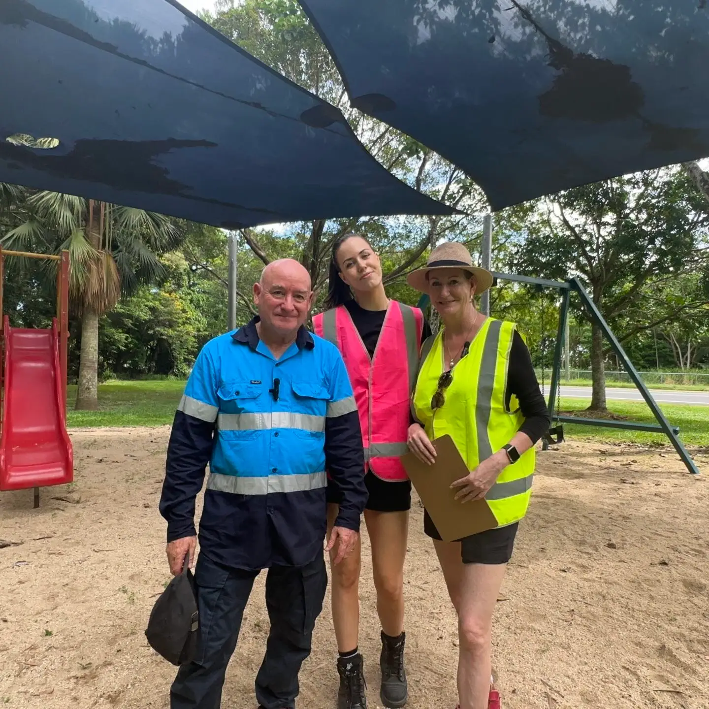 Inspectors pointing at shade sail