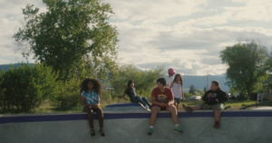 Youth gather on a deck by a bowl in a skatepark in Flathead Indian Reservation in the trailer shot of Keelan Williams’ 20-minute documentary Paving the Way.